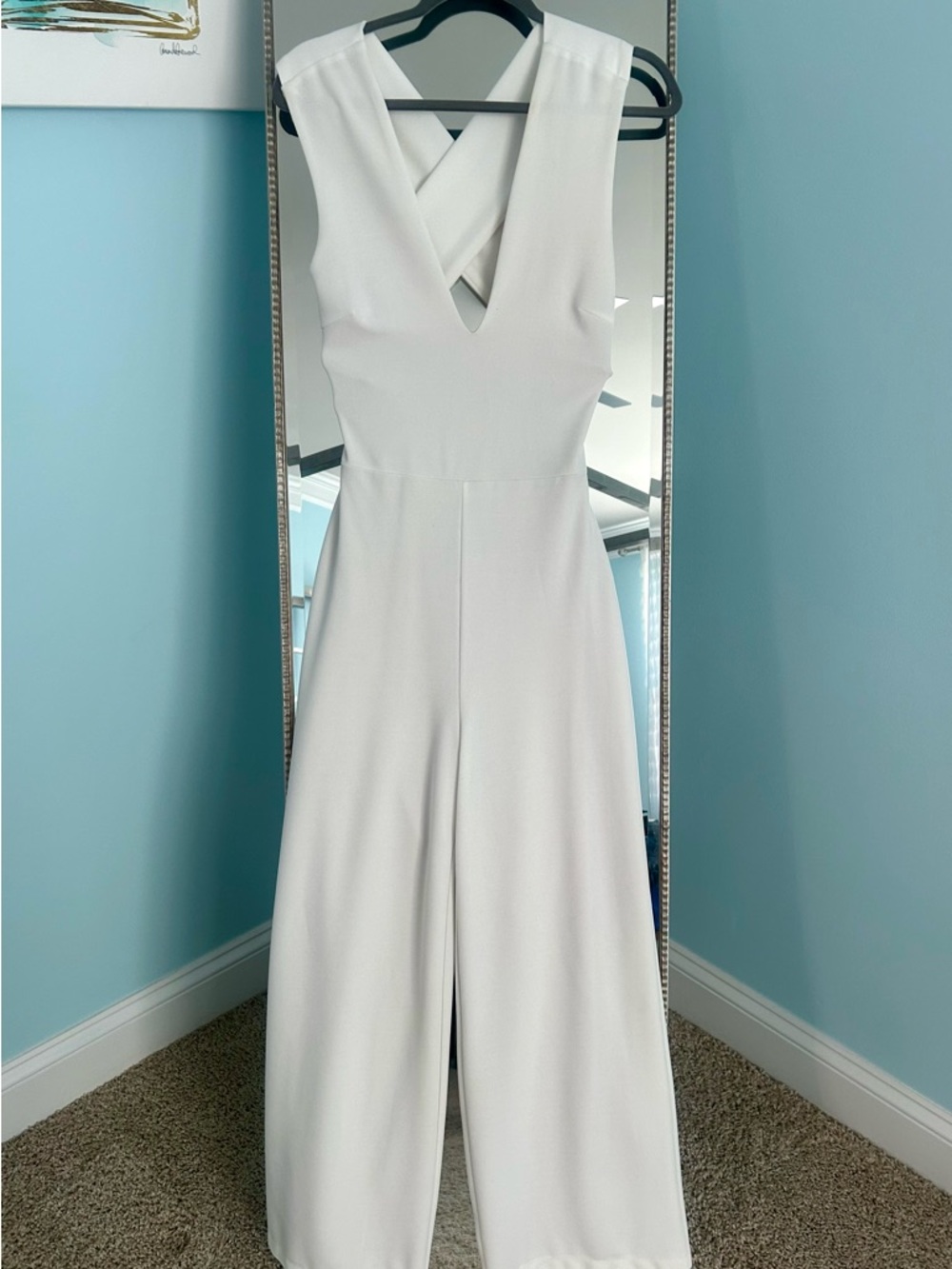 Sleeveless Deep V-neck White Wide-Leg Jumpsuit with Cross Back.